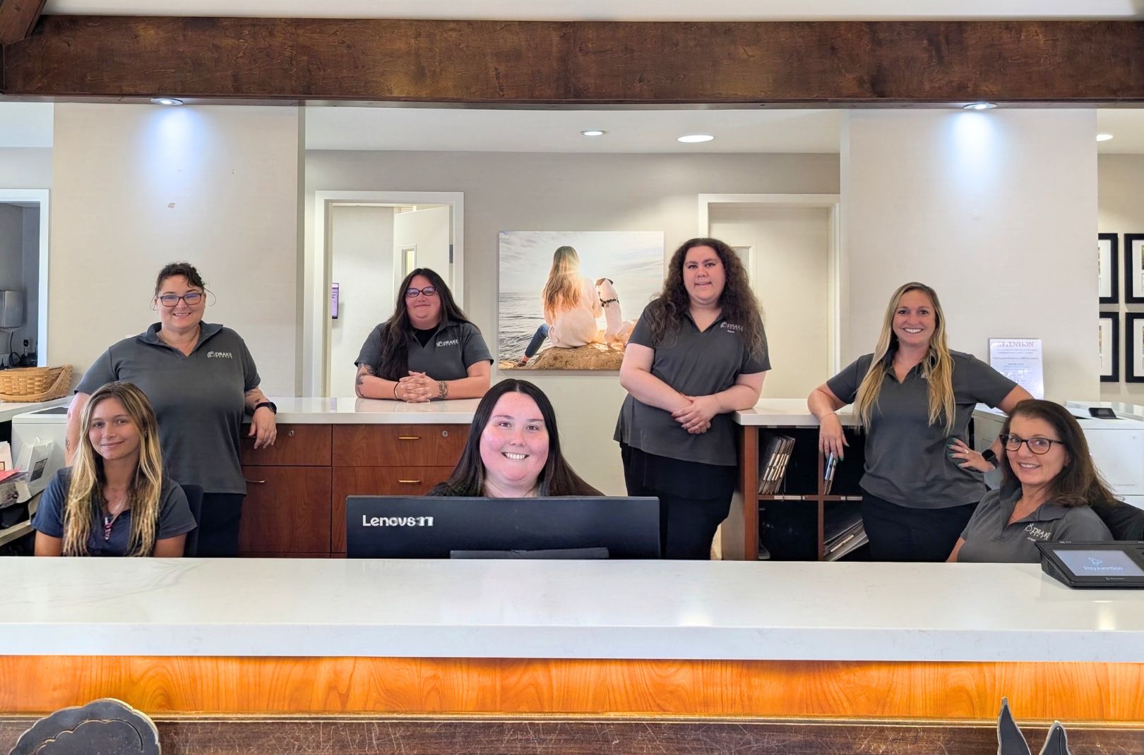 The team at The Drake Center sits at the front desk. 